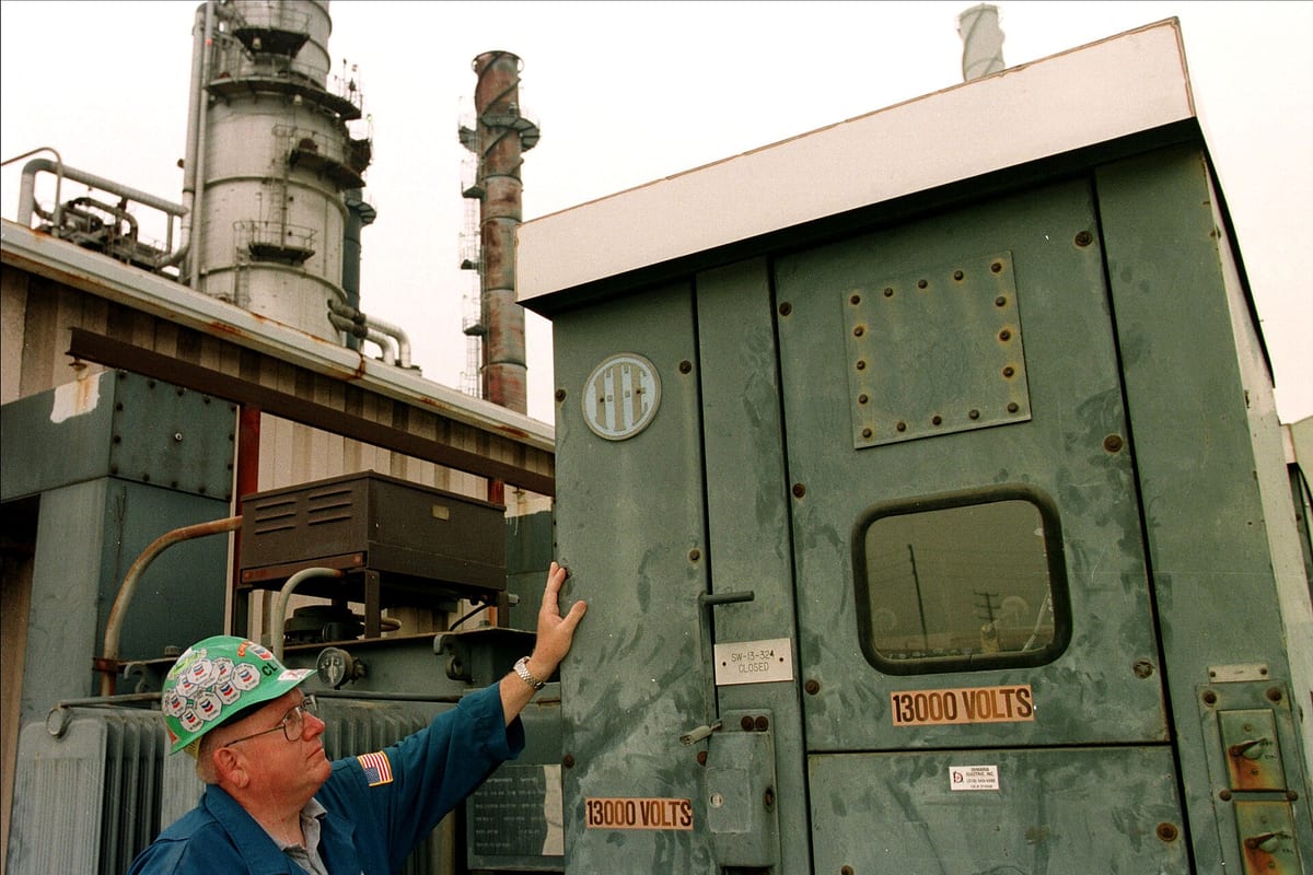 A worker beside electrical equipment at a refinery in El Segundo, California