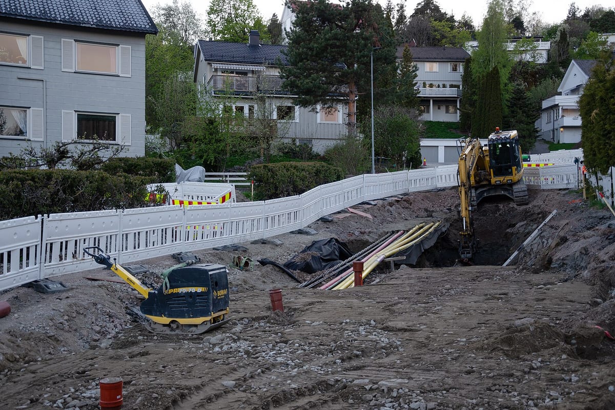 Excavation equipment and utility pipes at a residential construction site