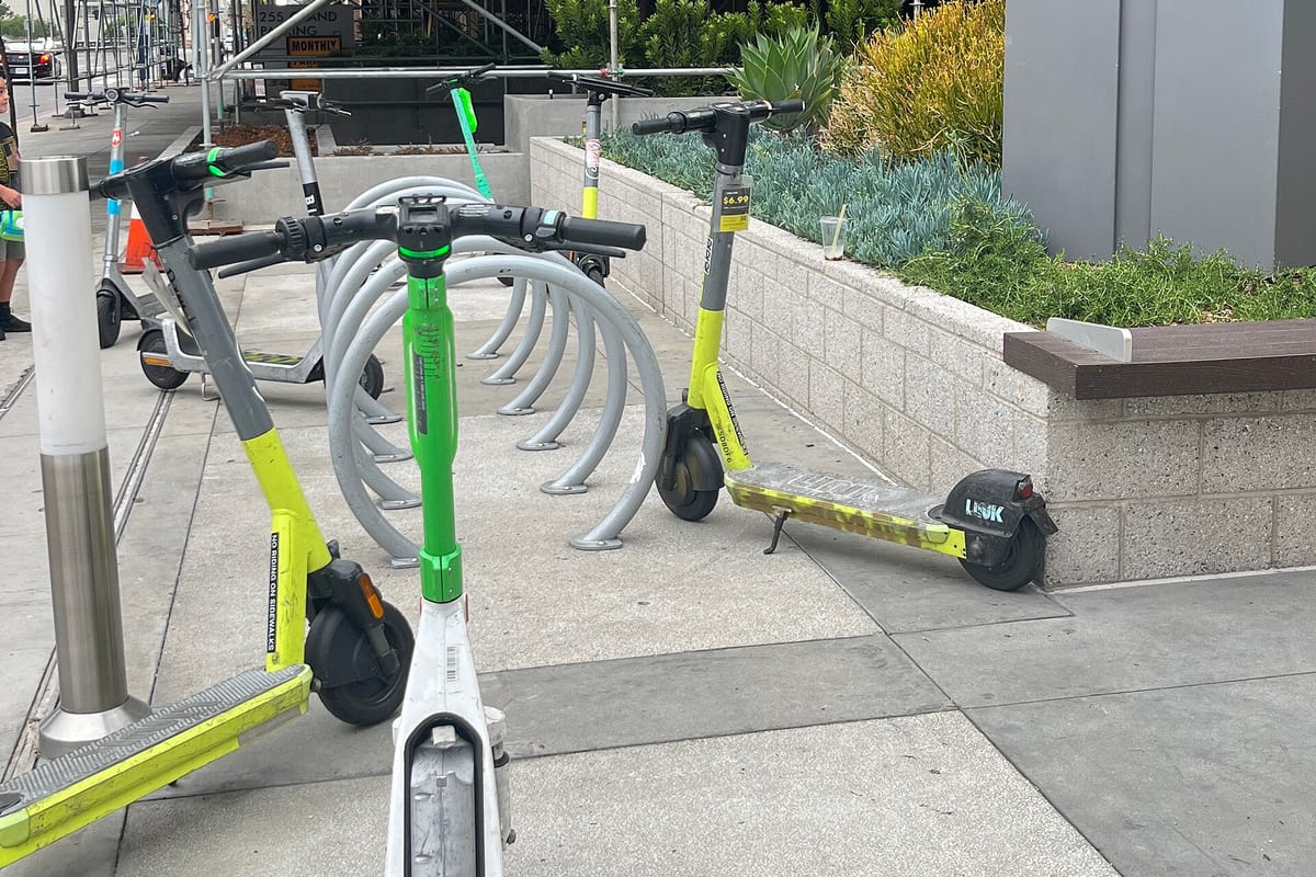Shared electric scooters parked on Grand Avenue in Los Angeles